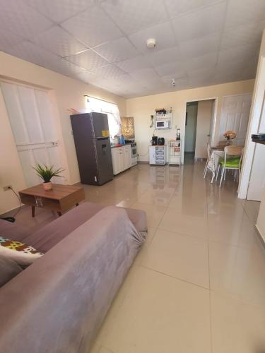 a large living room with a refrigerator and a table at sweet Home alto Boquete in Tortuga