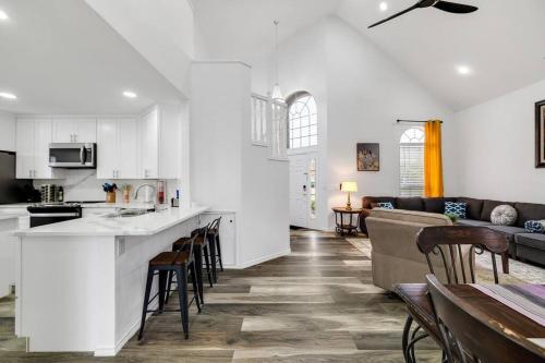 a kitchen and living room with a bar and a couch at Frisco Resort Style Home w/Spa in Frisco