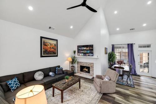 a living room with a couch and a fireplace at Frisco Resort Style Home w/Spa in Frisco