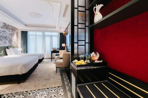 a hotel room with a bed and a red wall at SWORD LAKE Hotel in Hanoi