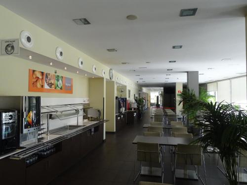 a restaurant with tables and chairs in a cafeteria at Holiday Inn Express Sant Cugat by IHG in Sant Cugat del Vallès