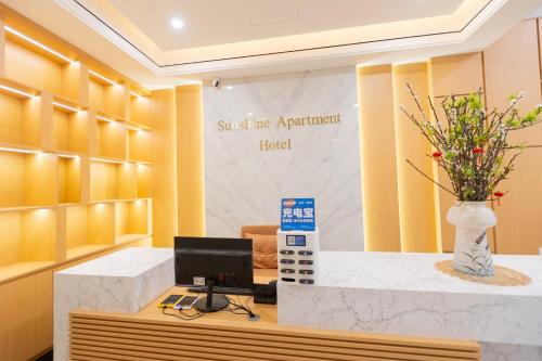 a office with a desk with a computer on it at Sunshine Apartment Hotel in Móng Cái