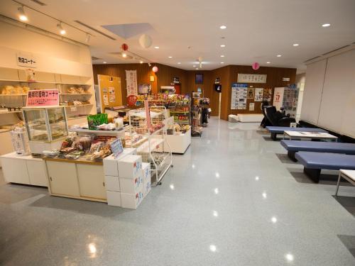 a store with a bakery with tables and chairs at Sun R in Rokugō