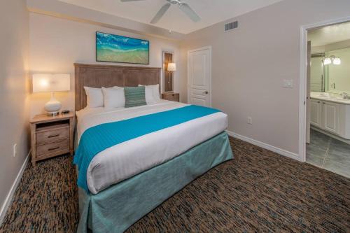 a bedroom with a large bed and a bathroom at Holiday Inn Club Vacations Panama City Beach Resort in Panama City Beach
