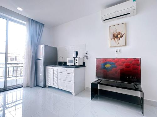 a white kitchen with a refrigerator and a counter at Thinh Vuong Apartment IX in Ho Chi Minh City