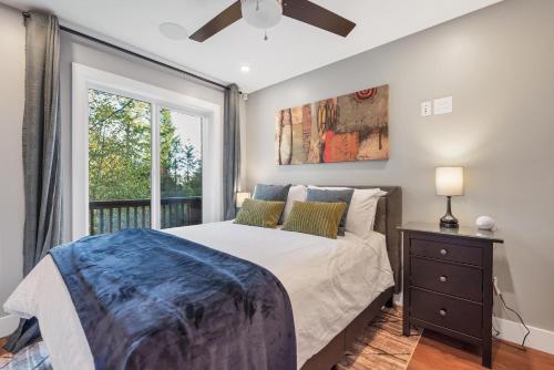 a bedroom with a large bed and a window at Vi Cottage in North Saanich