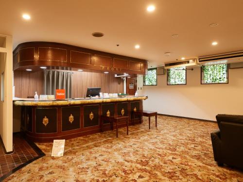 a large lobby with a bar in a room at ecoHotel in Toyama