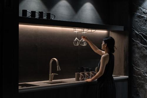 a woman is standing in front of a bathroom mirror at Yeojuhyeon in Daegu