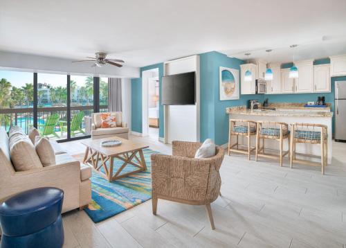 a living room with blue walls and a kitchen at Margaritaville Beach Resort South Padre Island in South Padre Island