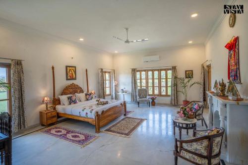 a bedroom with a bed and a living room at Castle Oodeypore A Boutique stay Udaipur in Udaipur