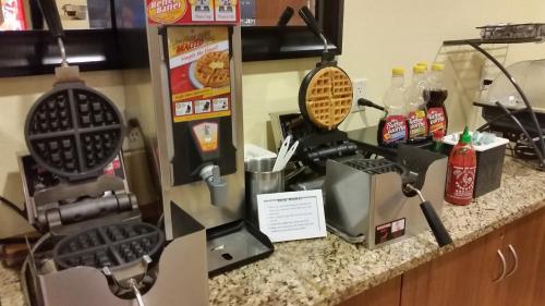 a kitchen counter with a coffee maker on it at Microtel Inn & Suites - Kearney in Kearney