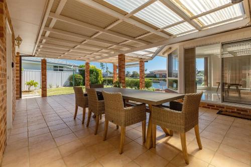 an indoor dining room with a table and chairs at 114 Elizabeth Pde in Forster