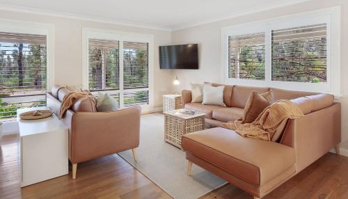 a living room with a couch and a tv at Weetaliba - Country Retreat in Yatte Yattah