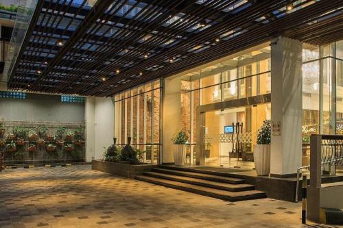 a lobby of a building with stairs and windows at THE 1O1 Yogyakarta Tugu in Yogyakarta