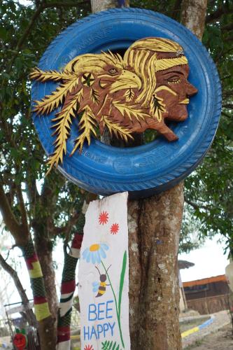 a blue frisbee is hanging on a tree at Pemsee's Tree Town - Eco-friendly,Tree house hostel in Sauraha