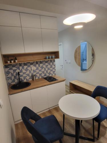 a kitchen with a table and chairs and a sink at Good Times Luxury Apartments Bitola in Bitola