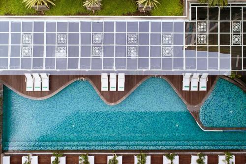 an overhead view of a building with a swimming pool at THE 1O1 Yogyakarta Tugu in Yogyakarta