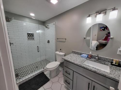 a bathroom with a toilet and a shower and a sink at Rare Find! Private Heated Pool & Spa - Entire Home Near ATL City Center in Atlanta