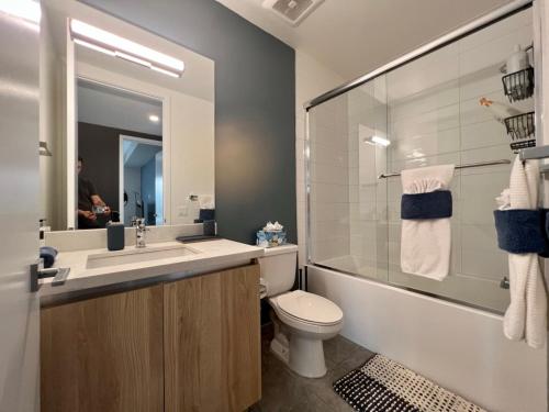 a bathroom with a sink and a toilet and a tub at Large Hollywood Corner 2 Bedroom with Private Balcony in Los Angeles