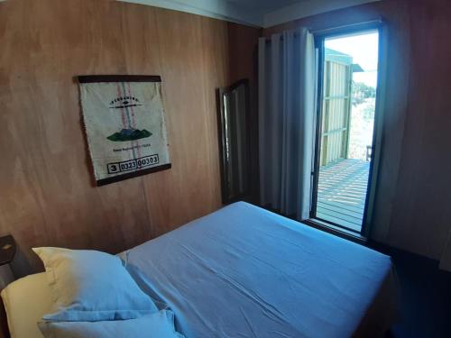 a bedroom with a blue bed with a window at Macchiato in La Pedrera