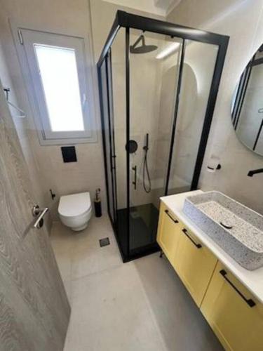 a bathroom with a shower and a toilet and a sink at Villa del Sol in Pesádha