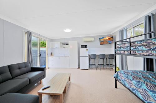 a living room with a couch and a bunk bed at Ned Kelly's Motel in Maryborough