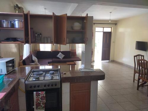 a kitchen with a stove and a counter top at Diani Breeze Villas in Diani Beach