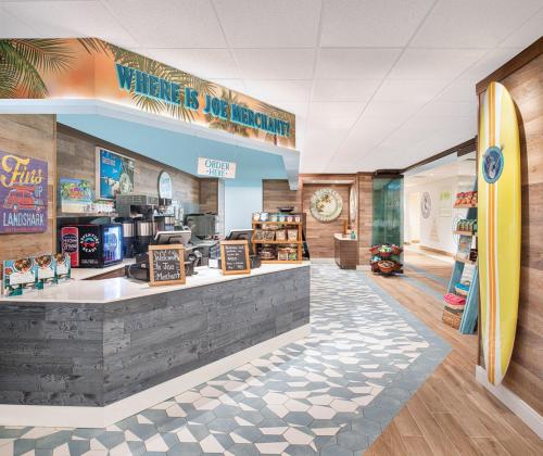 a surf shop with a surfboard on the wall at Margaritaville Beach Resort South Padre Island in South Padre Island