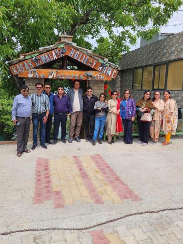 a group of people standing in front of a building at Kasar Himalaya Holiday Resort, Binsar Rd in Almora
