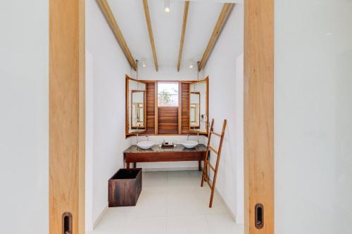 a bathroom with a sink and a window in a room at Cinnamon Hakuraa Huraa Maldives - All Inclusive in Meemu Atoll