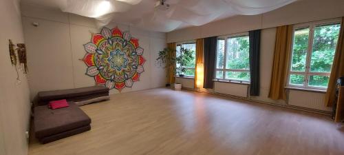 an empty room with a large painting on the wall at Good Life Homestay in Ahmovaara