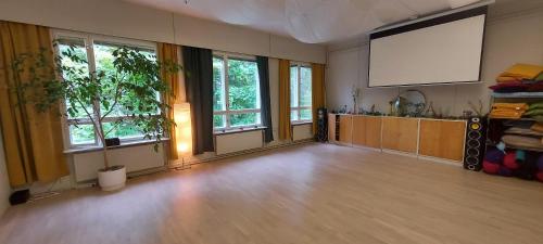 a large room with a projection screen in a building at Good Life Homestay in Ahmovaara
