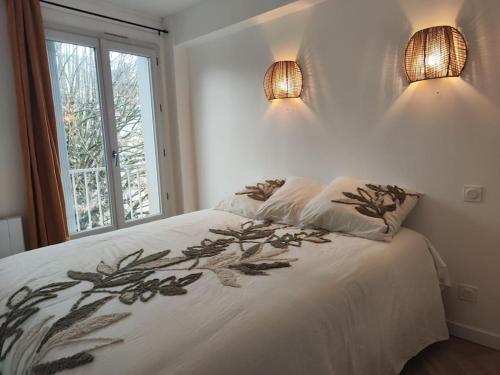 - une chambre dotée d'un lit avec deux lumières dans l'établissement Appartement T2 Petite Jade, à Luchon