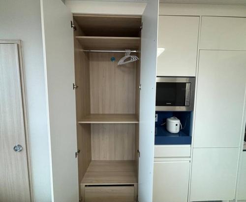 a kitchen with a cupboard with a microwave at Guil Property in Seoul