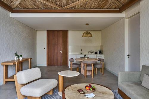a living room with a couch and a table at ERTH Abu Dhabi Hotel in Abu Dhabi