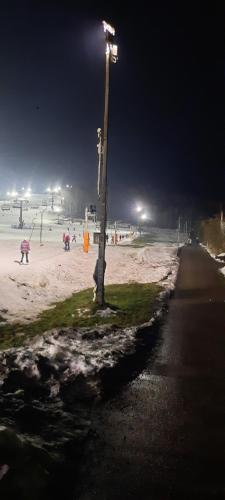 a street light on a beach at night at Pokoje u Juroszka in Istebna