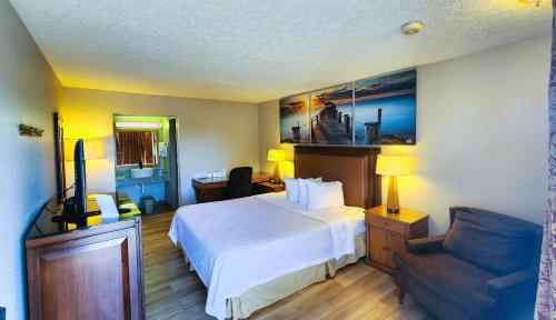 um quarto de hotel com uma cama e uma cadeira em Days Inn by Wyndham Frankfort em Frankfort