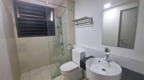a bathroom with a toilet and a sink and a shower at One Tebrau by Iconic Bliss in Johor Bahru