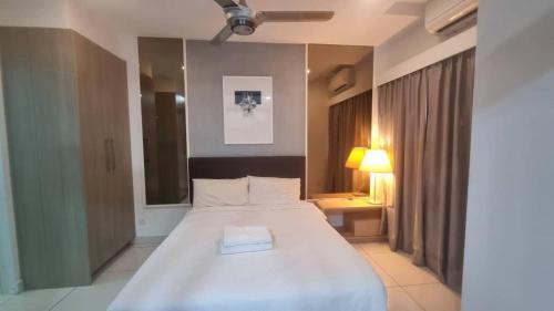 a bedroom with a large white bed in a room at One Tebrau by Iconic Bliss in Johor Bahru