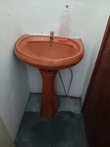 a bathroom with a brown sink in a room at Studio à port louis in Port Louis