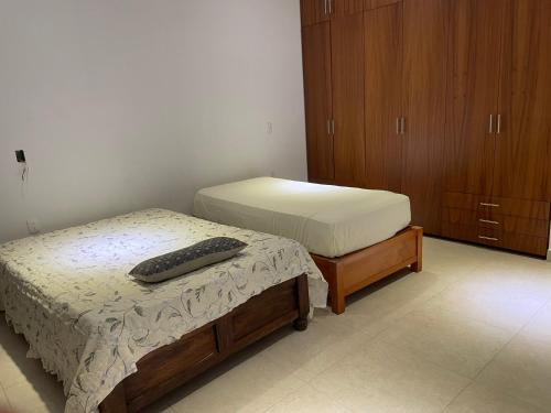 a bedroom with two beds and a keyboard on the bed at Casa Mezcal,guerrero3 in Mezcales