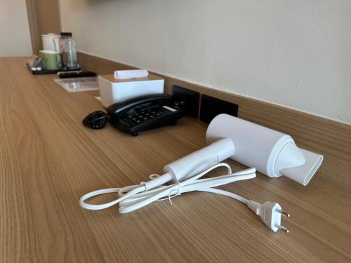 a corded phone sitting on top of a wooden floor at Jace hotel in Bangkok