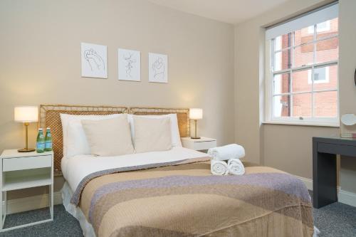 a bedroom with a bed with two towels on it at Best Covent Garden/Chinatown/Soho Location in London