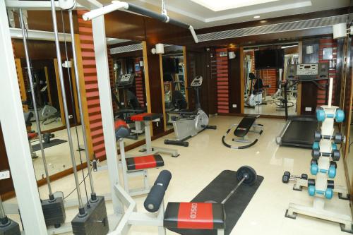 a gym with treadmills and equipment in a building at Sarovar Portico Rivera Ahmedabad in Ahmedabad