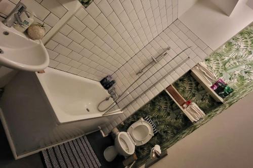 an overhead view of a bathroom with a toilet and a sink at Hidden Gem - One bedroom flat with private garden in Plumstead