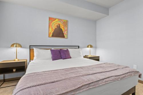 1 dormitorio con 1 cama blanca grande con almohadas moradas en Cozysuites PHX RORO Gym, Pool, Pets, Parking! #5 en Phoenix