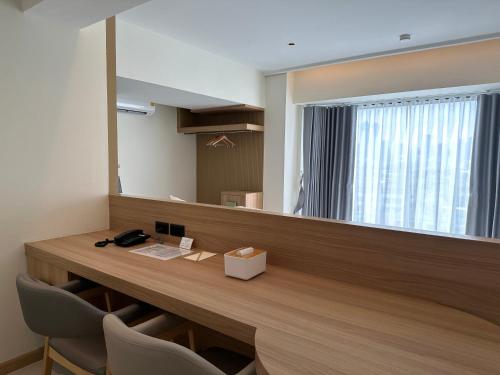 a reception desk in an office with a large mirror at Jace hotel in Bangkok