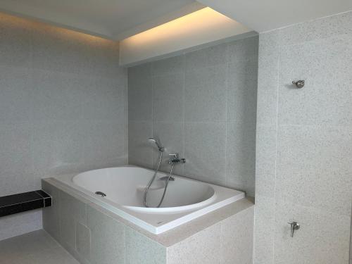 a bathroom with a bath tub in a room at Jace hotel in Bangkok