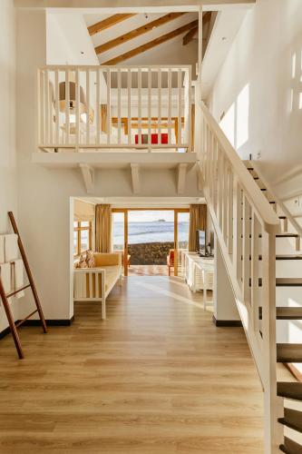 a living room with a loft bed and a staircase at Cinnamon Dhonveli Maldives in North Male Atoll