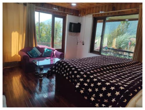 a bedroom with a bed and a couch and a window at Hotel Hamdard INN in Pahalgām